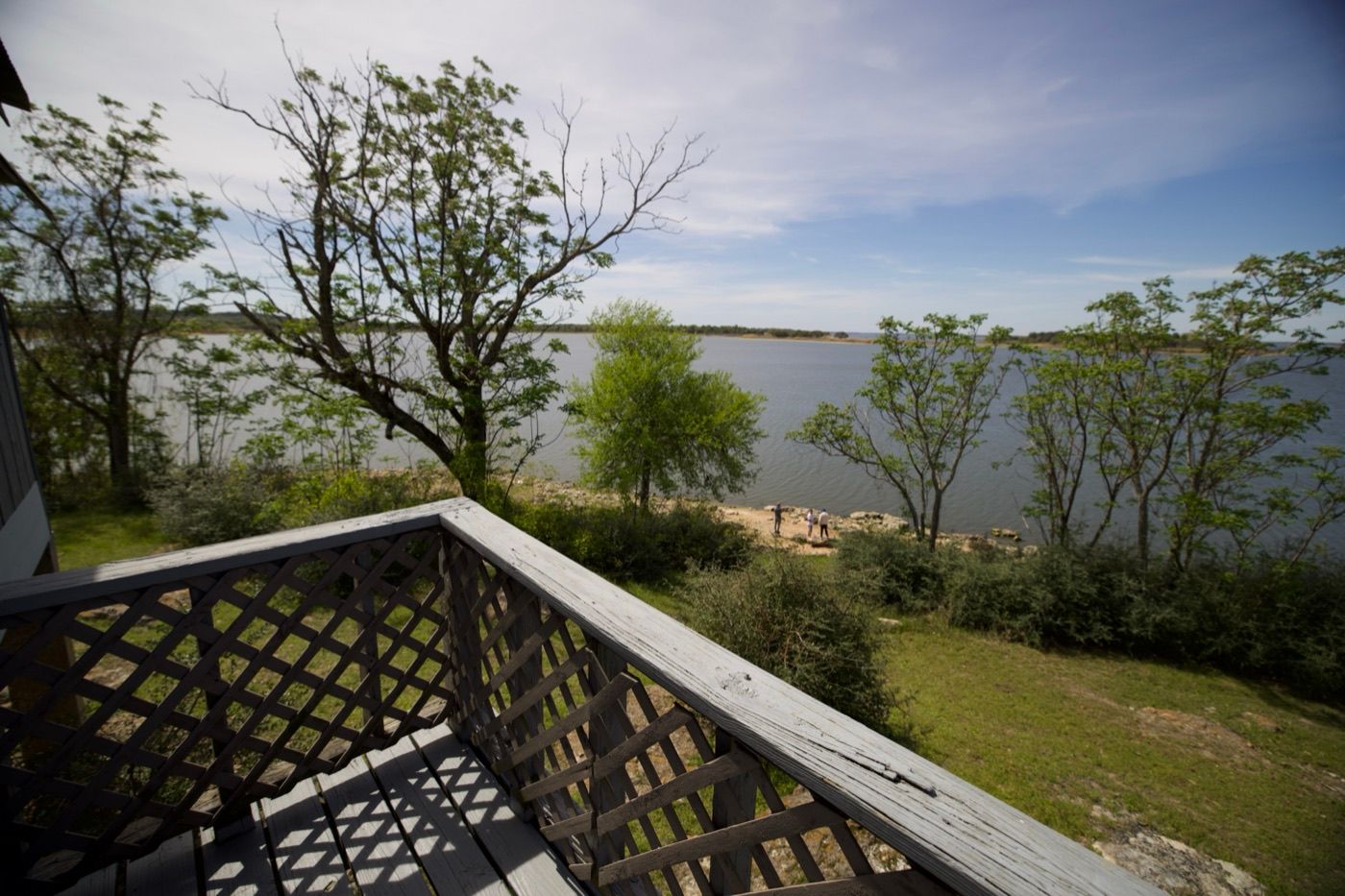 View over the deck railing of a cabin looking out across Lake Somerville